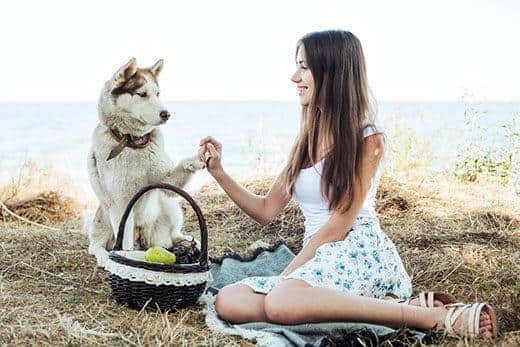 Jeune femme tenant un husky de Sibérie roux