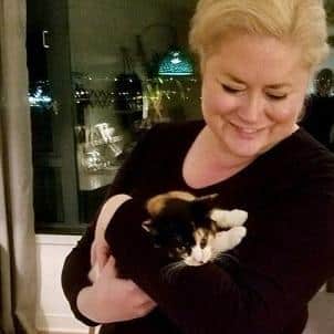 Woman holding a calico kitten